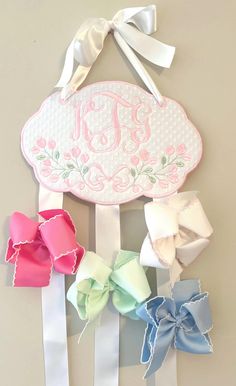 🎀🎀This is an adorable way to store and display your daughter's bows. It is a wonderful baby shower gift, birthday gift, or welcoming gift.  🎀This listing is for one bow holder. It is made with high quality swiss dot or pique bitty dot fabric. The back is covered so no embroidery will show through.  🎀 Approximate size is 9.50"x 6.50" Disclaimer: This is not a toy and is to be used for decoration purposes.  Returns: I do not accept returns due to the personalization of the product. Please mess Bow Organizer Nursery, Baby Monogram Ideas, Bow Holder Diy, Paris Nursery, Diy Bow Holder, Hair Bow Display, Hair Bow Ribbon, Bow Display, Monogram Kids