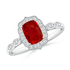 a ring with an oval shaped red stone surrounded by white diamonds