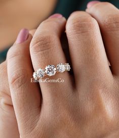 a woman's hand with three diamond rings on her left and the middle finger