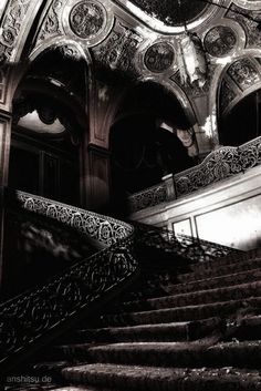 an ornate staircase in a building with intricate designs on the railings and handrails