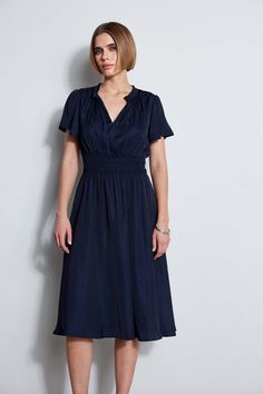 This modern Midi Dress designed in a soft georgette has an effortless silhouette & fit. The feminine flutter sleeves, split neck & smocked waist will make it your next favorite dress. Wear it with pumps or dress it up with sexy sandals for brunch or a night out. T-Tahari Short Flutter Sleeve Midi Dress with Smocking at the Waist Runs true to size. Model is 5'9" and wearing size S Imported Style #: THF46012 Elegant V-neck Midi Dress With Elastic Waistband, Elegant V-neck Dress With Smocked Bodice, Elegant Short Sleeve Dress With Smocked Bodice, Elegant Empire Waist Midi Dress With Smocked Back, Elegant Dress With Smocked Back And Short Sleeves, Elegant Midi Dress With Smocked Back, Elegant Dresses With Smocked Bodice And Fitted Waist, Elegant Midi Dress With Smocked Bodice And Empire Waist, Elegant Fitted Midi Dress With Split Neck