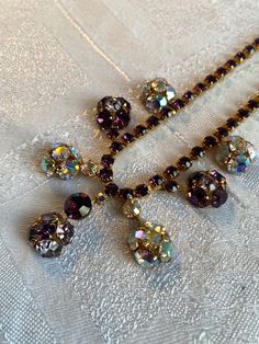 Unusual diamanté necklace, mid century, purple amethyst and aurora borealis stones  In very good condition with no missing stones  It measures 15 inches long but an extender chain could be added Sparkles like crazy in the light!! Purple Crystal Necklaces With Jewels, Purple Vintage Jewelry For Party, Vintage Purple Jewelry With Rhinestones, Vintage Purple Rhinestone Jewelry, Purple Vintage Jewelry With Rhinestones, Necklace Purple, Crystal Necklaces, Like Crazy, Aurora Borealis