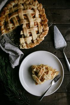 an apple pie on a plate with a slice cut out and the rest half eaten