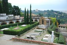 an outdoor garden with stone benches and greenery