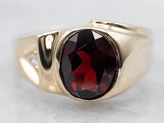 "Look as vibrant and elegant as a sunny day with this glimmering garnet ring! The shining stone stands out against the yellow gold band, flanked by a diamond accent for a bit of extra sparkle. Shine on! Metal: 10K Yellow Gold Gem: Garnet 2.74 Carats Gem Measurements: 7.4 x 9.8 mm, Oval Accent: Diamond .05 Carats, SI2 in Clarity, G in Color Ring Size: 10.50 Marks: \"10K\" Stamped on the inside band SKU #: A32365 Each piece has been identified and graded by a Graduate Gemologist who has been certi Pyrope Garnet, Garnet And Diamond Ring, Gold Gift, Color Ring, Garnet Rings, Pearl Pendant, Gold Bands, Shop Necklaces, Shop Earrings