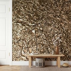 a room with a wooden table and gold wallpaper