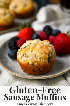 a muffin on a plate with strawberries and blueberries in the background text reads gluten - free sausage muffins