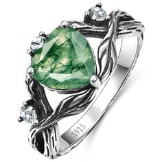 a ring with an oval green stone surrounded by leaves and diamonds on the sides, set in