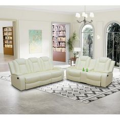 a living room with two white couches and a rug