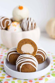 several chocolate covered donuts on a plate with white frosting and sprinkles