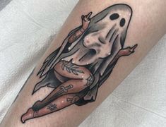 a woman with a ghost tattoo on her leg