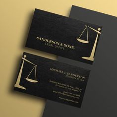 two black and gold business cards with an image of a scales of justice on them