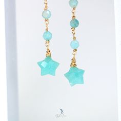 These elegant blue green Amazonite natural stones star dangle drop earrings feature a long trail of 4 mm faceted Amazonite stones and a faceted carved star Amazonite stone drop at the end. The ear wires are solid 925 sterling silver, the Amazonite stones are wire wrapped using brass wires. Add these elegant star Amazonite dangle drop earrings to your everyday fine jewelry collection or as a gift for your loved one. There are two metal color option:Silver: sterling silver ear wires, stainless steel wire wrapGold: gold plated sterling silver ear wires, brass wire wrap. Dimensions: 3.14 x 0.40 in Jewelry Care: See more information about how to care for your jewelry here. Shipping Policy: Orders will be shipped within 1-3 business days. Economy shipping will take 7-14 days to arrive and standa Dainty Dangling Beads Earrings As Gift, Briolette Dangling Beads Earrings Gift, Dainty Dangling Bead Earrings For Gifts, Dainty Earrings With Dangling Beads For Gift, Sterling Silver Linear Earrings With Dangling Beads For Gift, Gift Briolette Earrings With Dangling Beads, Faceted Beads Dangle Jewelry Gift, Faceted Beads Dangle Earrings For Gift, Gift Faceted Beads Drop Earrings