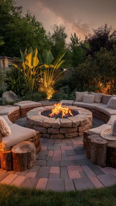 an outdoor fire pit surrounded by stone seating