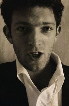 black and white photograph of a young man making a funny face with his tongue out