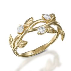 a gold ring with leaves and diamonds