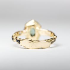 Details:One of a kind Bi-color Oval Peacock Montana Sapphire Ring. The stones have been set in 18k Yellow Gold (Eco Recycled Gold)Metal: 18K Yellow GoldStones: SapphireTCW: 1.15Please note: Each piece is truly unique from every other as a result of the cast in wood process. The wood defines the form of the metal and the settling of the stones. Stone color may vary, some stones may be buried, and the grain will individually shape the piece in completely unpredictable ways. Only the care and atten Yellow Gold Multi-stone Oval Cabochon Gemstones, Yellow Gold Oval Fusion Jewelry, Fusion Style Oval Yellow Gold Jewelry, Heirloom Multi-stone Oval Cabochon Rings, Fusion Style Yellow Gold Rings With Gemstone Accents, Oval Yellow Gold Emerald Ring With Multiple Stones, Oval Yellow Gold Emerald Ring With Multi-stone, Luxury Gold Tourmaline Rings, Luxury Oval Tourmaline Ring