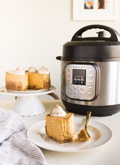 a piece of cake on a plate next to an instant pot