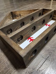 two wooden trays with red arrows on them