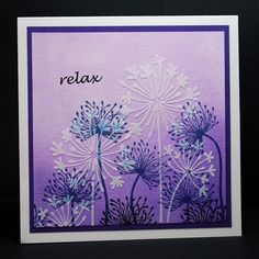 a greeting card with dandelions and the word relax