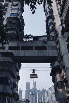 an overhead view of a city with tall buildings and a person on a lift in the air