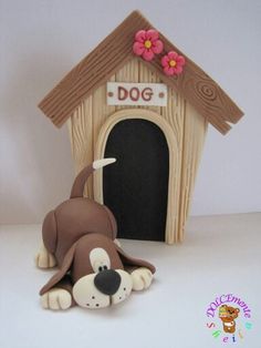 a dog is laying in front of a wooden dog house