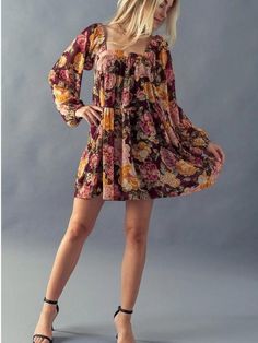 Fall in Love in this Floral Babydoll Dress. The dress has long cuffed sleeves, a trendy square neckline, and a tiered babydoll design. The mini length gives the dress a flirty vibe paired with some knee-high boots. The floral print has beautiful burgundy, orange, and pink Fall hues making this piece a must-have this season. The dress has an inner lining with a sheer overlay. Fabric: 100% Polyester (Self and Lining) Includes x1 Dress. Sizes S-M-L; Regular Sizing. Flowy Square Neck Mini Dress With Ruffles, Fall Mini Dress With Ruffles And Square Neck, Fall Square Neck Dress With Ruffle Hem, Flowy Square Neck Mini Dress For Fall, Fall Mini Dress With Ruffle Hem And Square Neck, Flowy Tiered Mini Dress For Fall, Square Neck Tiered Dress With Ruffle Hem For Brunch, Fall Floral Print Mini Dress With Square Neck, Floral Print Mini Dress With Square Neck For Fall