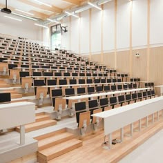 an empty lecture hall with rows of chairs