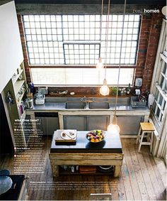 an aerial view of a kitchen and living room in a loft style home with wood flooring