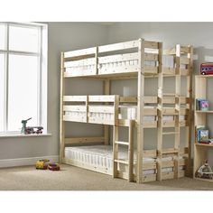 there is a bunk bed in the room with two shelves on each side and a window behind it