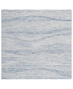 a white and blue rug with wavy lines