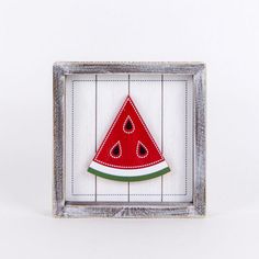 a watermelon slice in a frame on a white background