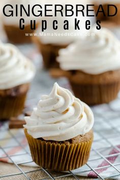 cupcakes with white frosting sitting on top of a cooling rack and text overlay that reads gingerbread cupcakes