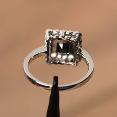 It is a natural black spinel ring, princess cut, measures 5mm*5mm, weight about 0.54 cts. The basic metal is sterling silver and plated with rhodium. To change the metal to a solid gold (white/rose) or platinum is also available, please ask for a quotation if you want. You can also go to my shop Home for more elegant rings: https://www.etsy.com/shop/godjewelry?ref=hdr_shop_menu More black spinel rings: https://www.etsy.com/shop/godjewelry?ref=seller-platform-mcnav&section_id=21680005 Customi Black Spinel Ring, Spinel Ring, Princess Cut Rings, Black Spinel, Elegant Ring, Princess Cut, Promise Rings, Silver Fashion, Heart Ring