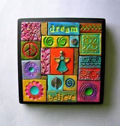 a colorful magnet with the words dream and peace painted on it's side, sitting on a white surface