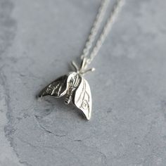 A tiny woodland moth, hand-carved and cast in sterling silver - a perfect gift for nature lovers. Moths are guided by the moon and fly fearlessly towards moonlight; wear this pendant as a symbol of your own bravery and self-belief. This delicate moth pendant hangs on an 18 inch fine silver chain. The pendant is small and delicate, dimensions are 14mm x 13mm. It can be worn alone or layered with other jewellery. Also available as a larger silver hawk moth necklace, as pictured: https://www.etsy.c Moth Pendant, Moth Necklace, Woodland Jewelry, Dope Jewelry, Rose Jewelry, Funky Jewelry, Gifts For Nature Lovers, Dream Jewelry, Pretty Jewellery