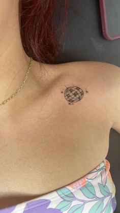 a woman with a small tattoo on her shoulder