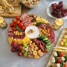 a platter filled with lots of different types of meats, cheeses and vegetables