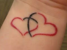 a couple of hearts on the wrist tattoo