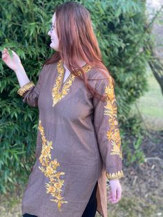 Kashmiri murti is a type of warm and comfortable maxi kurti. We are presenting this traditional garment in it's modern version handmade from cotton and silk blend and embellished with stunning Kashmiri embroidery. The embroidery is in the neckline with embroidered detail on the sleeves and borders.  Practical and comfortable, it is a practical everyday wear especially good looking with leggings. The kurti is slightly transparent as you can see on the picture and It is also perfect to throw over Brown Tunic Kaftan For Spring, Spring Brown Tunic Kaftan, Festive Long Sleeve Brown Kurta, Long Sleeve Kurta With Dabka Work For Fall, Traditional Long Sleeve Brown Kurta, Embroidered Border Tunic Kurta For Festivals, Embroidered Tunic Kurta For Festivals, Bohemian Kurta With Resham Embroidery For Fall, Bohemian Resham Embroidered Kurta For Fall