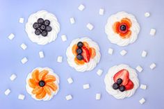 four desserts with fruit on top and ice cubes around them stock images, food photography