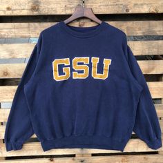 Vintage 90s NCAA Georgia Bulldogs Football University Sweatshirt Georgia Crewneck Georgia Sweater Embroidery Logo Blue Color Men's XL Label : CLASSIC SOFFE Label Size : XL Made in PAKISTAN Materials from 50% Cotton 50% Polyester Used Item With Condition 6/10 Refer Picture. Stain and No Holes. Lay Down Flat Measurement : - Width (armpit to armpit) and: 25.5 Inches - Length (shoulder to end of garment): 27 Inches We are selling used clothing with good condition. DO NOT EXPECT the item is like new condition. Shipping: DHL/FEDEX EXPRESS with TRACKING NUMBER. Track and Trace http://www.dhl.com http://www.fedex.com Parcel will be arrive within 3-6 business days or more due to location and custom clearing. Please PROVIDE your PHONE/CONTACT NUMBER for SHIPPING/DELIVERY purpose. VERY IMPORTANT ‼ fo Vintage College Sweatshirt With Embroidered Logo, Vintage Sweatshirt With Embroidered Logo For College, Vintage Embroidered Logo Sweatshirt For College, Vintage Letter Embroidery Sweatshirt For Streetwear, Vintage Embroidered College Top, Vintage Embroidered Graphic Top For College, Vintage Embroidered Graphics Top, Vintage Cotton Tops With Letter Embroidery, Vintage Embroidered Tops For College