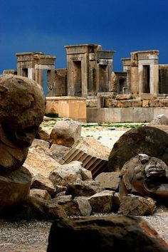 the ruins of an ancient city are shown in this image, with large rocks surrounding them