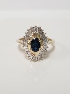 "Thanks for shopping our vintage estate store. We tend to sell well below wholesale and truly hope you enjoy all of our items. Many of the items are one of a kind, so please enjoy scrolling through the pictures and hopefully something will catch your eye. Black spots are from camera or reflections. Estate 10k yellow gold natural oval .50ct sapphire .50ct diamond cocktail style ring. There are 22 baguette diamonds in the setting, and the sapphire is testing natural. Ring size: 6.75 Setting: 3/4\" Classic Oval Sapphire Ring, Vintage Oval Sapphire Ring With Diamond Cut, Vintage Sapphire Ring With Diamond Cut, Oval Shape, Classic Collectible Cluster Ring With Diamond Cut, Collectible Oval Sapphire Ring With Diamonds, Oval Diamond Cluster Ring Collectible, Collectible Oval Sapphire Diamond Ring, Classic Oval Cluster Ring With Prong Setting, Classic Oval Cluster Ring With Halo Setting