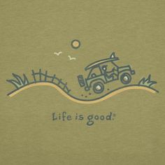 a green t - shirt with an image of a car driving down the road and life is good written on it