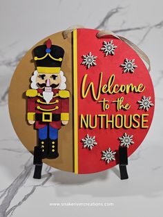 a nutcracker is standing next to a sign that says welcome to the nuthouse