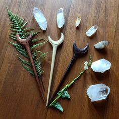 several different types of tools on a table with rocks and plants in the foreground