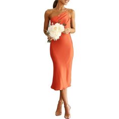 a woman in an orange dress holding a bouquet