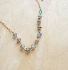 "Dainty Gold Labradorite Gemstone and Turquoise Crystal Necklace❤ Ten dainty natural labradorite gemstone rondelles (~6x4mm) are wire wrapped in 14kt gold filled wire beside two petite turquoise crystals (4x3mm), and suspended from two strands of delicate and shimmering gold filled flat cable chain. Delicate and minimalistic, yet eye catching. The turquoise crystals pair nicely with the blue flash of the labradorite gems. Necklace measures 17-inches, with a 2-inch extender on the clasp.  ♥Your p Adjustable Labradorite Gemstone Bead Necklace, Adjustable Labradorite Necklaces With Round Beads, Labradorite Gemstone Bead Crystal Necklaces, Labradorite Gemstone Crystal Necklaces With Round Beads, Handmade Labradorite Round Bead Necklaces, Handmade Labradorite Bead Necklace, Labradorite Gemstone Beads Necklace Gift, Faceted Labradorite Round Beads Jewelry, Dainty Round Gemstone Beaded Necklace