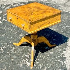 an old wooden table sitting in the middle of a parking lot with no one around it